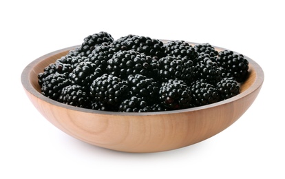 Wooden bowl of tasty ripe blackberries on white background