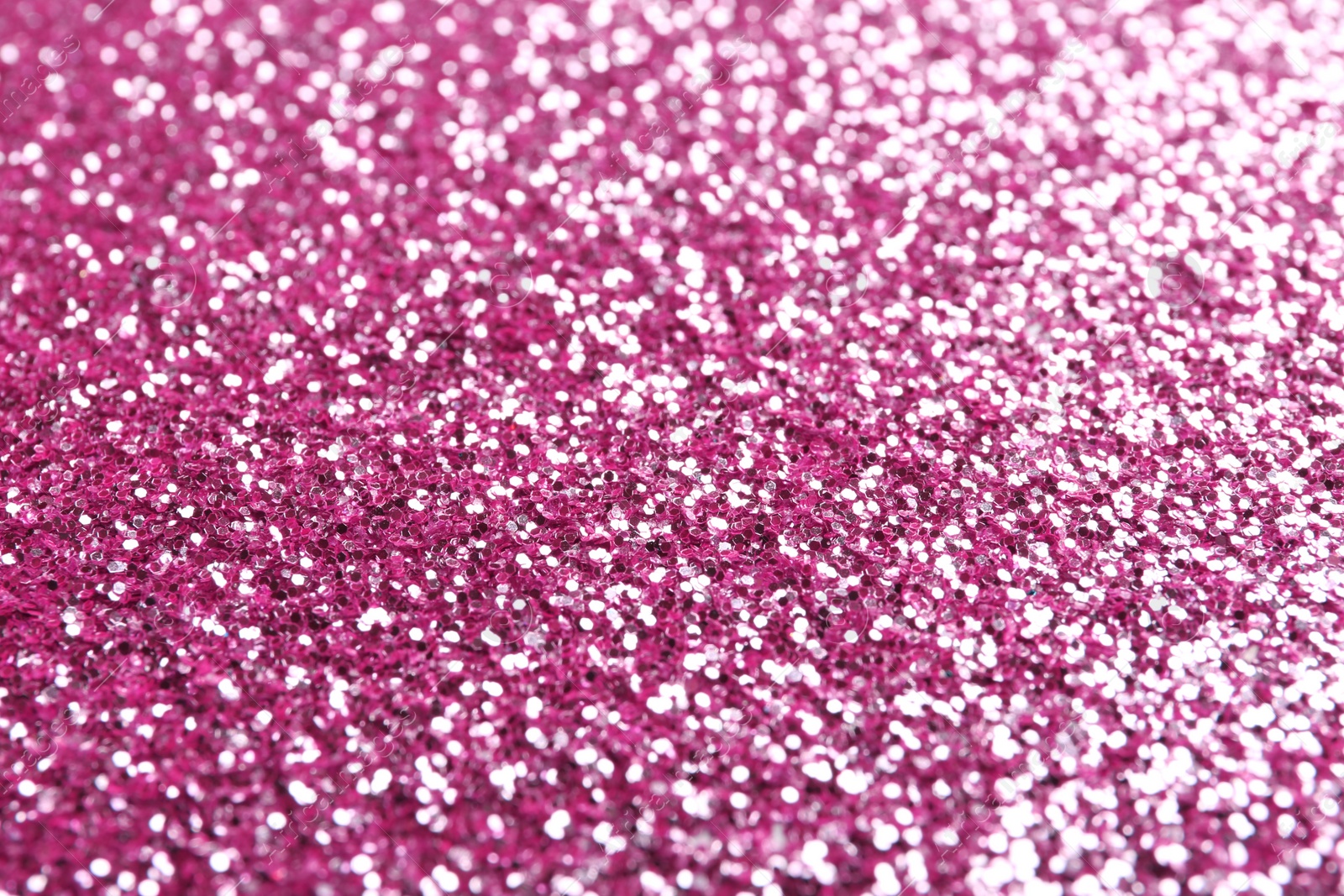 Photo of Closeup view of sparkling pink glitter background