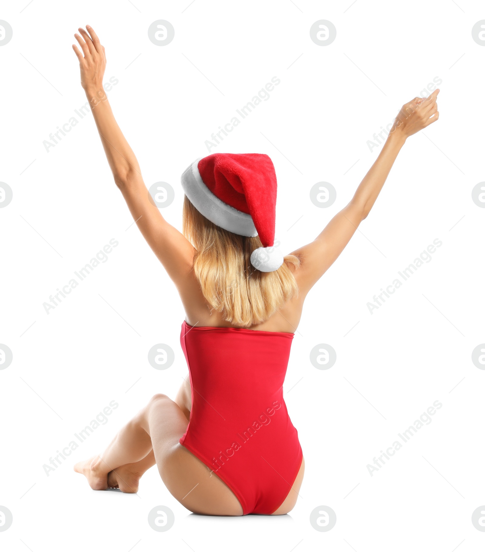 Photo of Young woman wearing Santa Claus hat on white background, back view. Christmas vacation