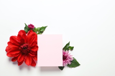 Photo of Flat lay composition with beautiful dahlia flowers and blank card on white background