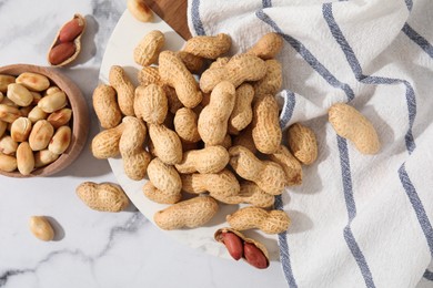 Photo of Fresh peanuts on white marble table, flat lay