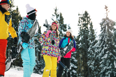 Group of friends with equipment in snowy mountains. Winter vacation