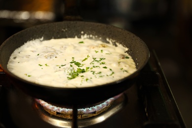 Photo of Cooking delicious noodles with melted cheese on frying pan