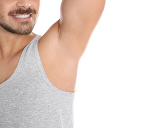 Photo of Young man showing armpit on white background, space for text. Using deodorant