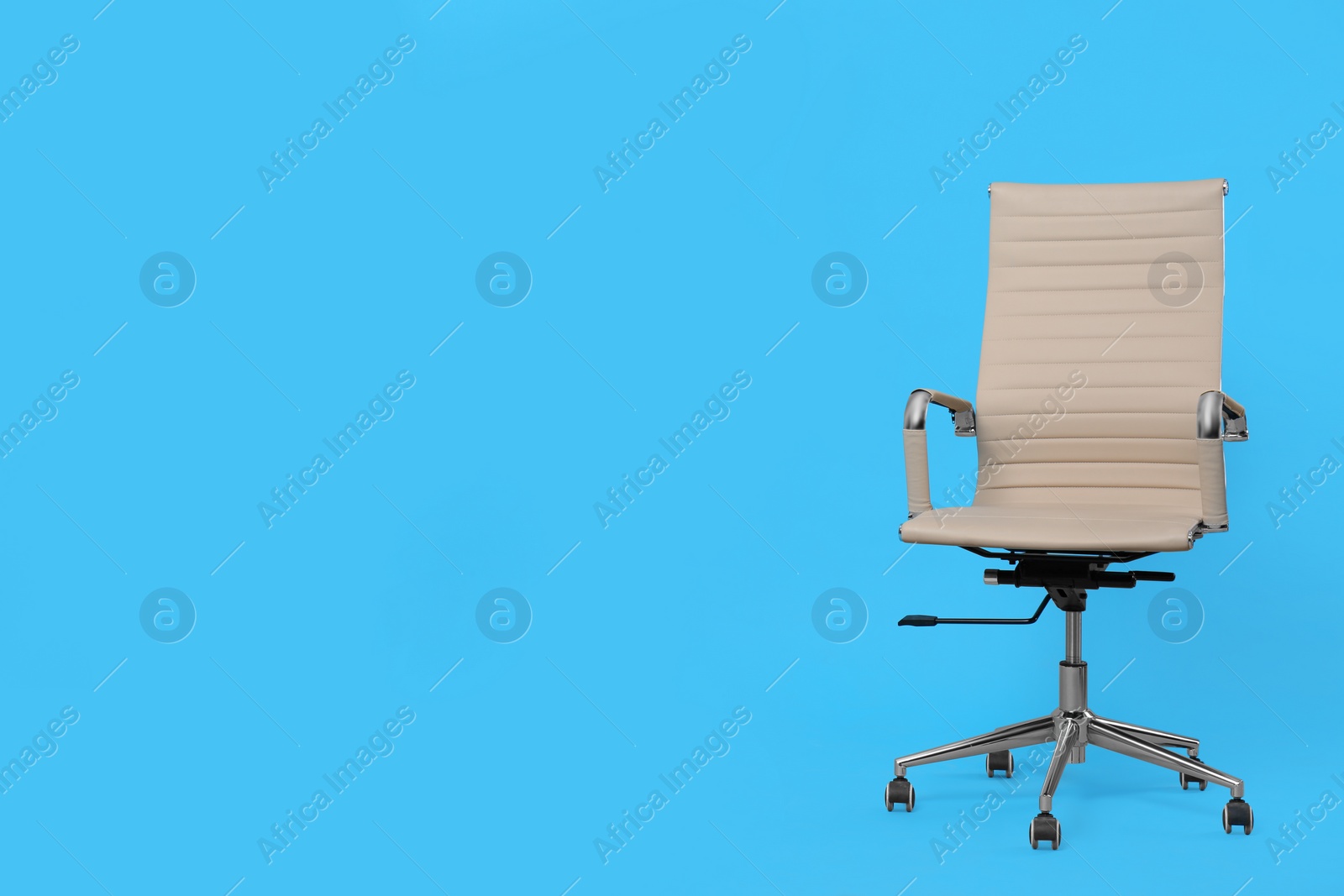 Photo of Comfortable office chair on light blue background, space for text