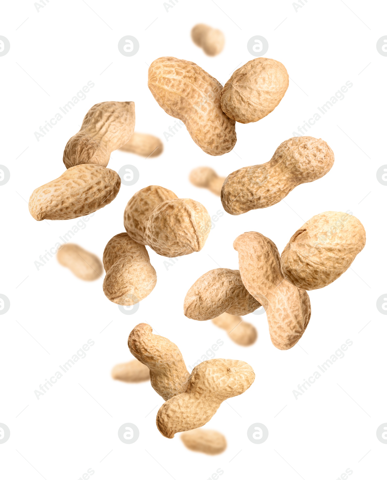 Image of Unpeeled peanuts in air on white background