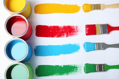 Photo of Flat lay composition with paint cans and brushes on white background