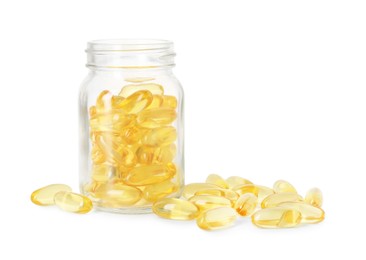 Photo of Bottle and pile of softgel capsules isolated on white