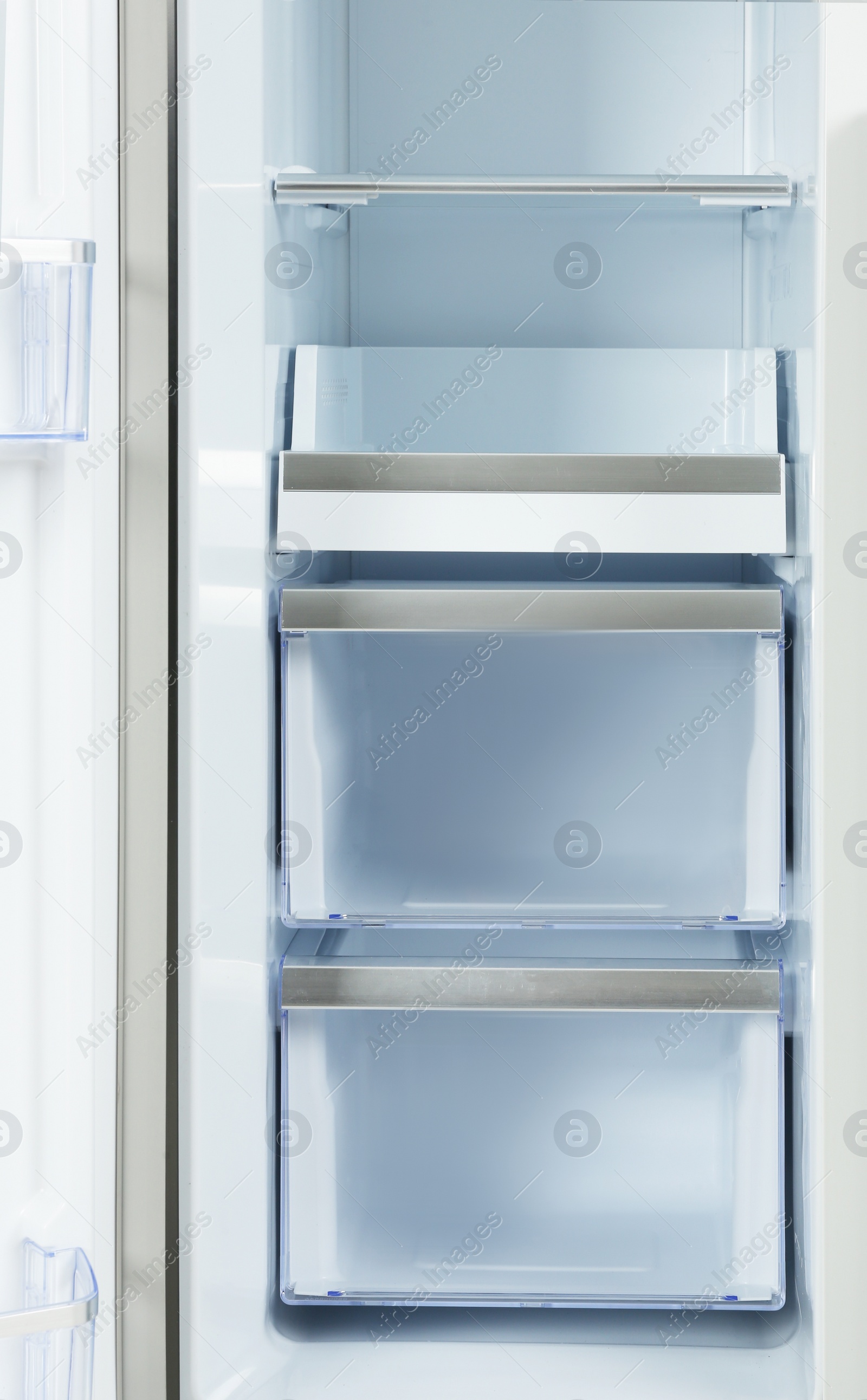 Photo of Shelves of empty modern refrigerator, closeup view