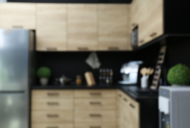 Photo of Blurred view of kitchen interior with modern furniture
