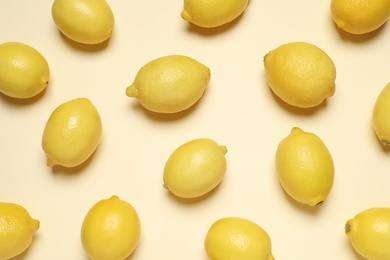 Photo of Fresh ripe lemons on beige background, flat lay