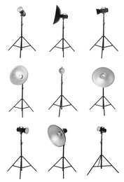 Image of Set with studio flash lights with reflectors on tripods against white background