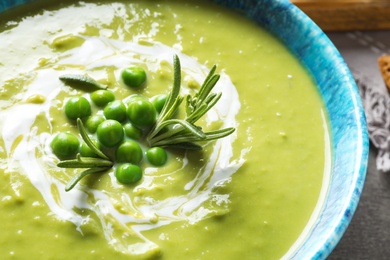 Fresh vegetable detox soup made of green peas in dish, closeup