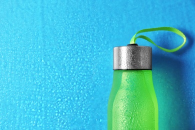 Sports water bottle on color background. Space for text