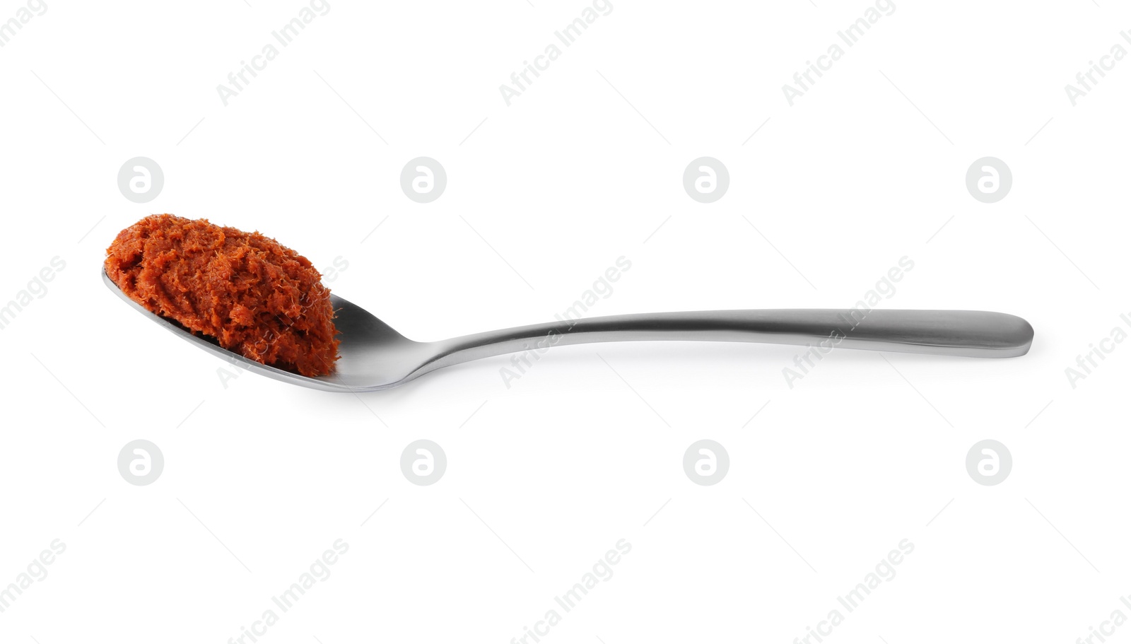 Photo of Tasty curry paste in spoon isolated on white