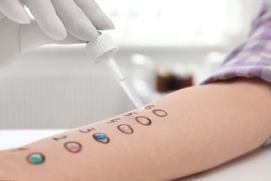 Photo of Patient undergoing skin allergy test at light table, closeup