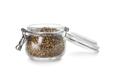 Jar with hemp seeds on white background