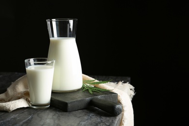 Photo of Composition with hemp milk on table against black background