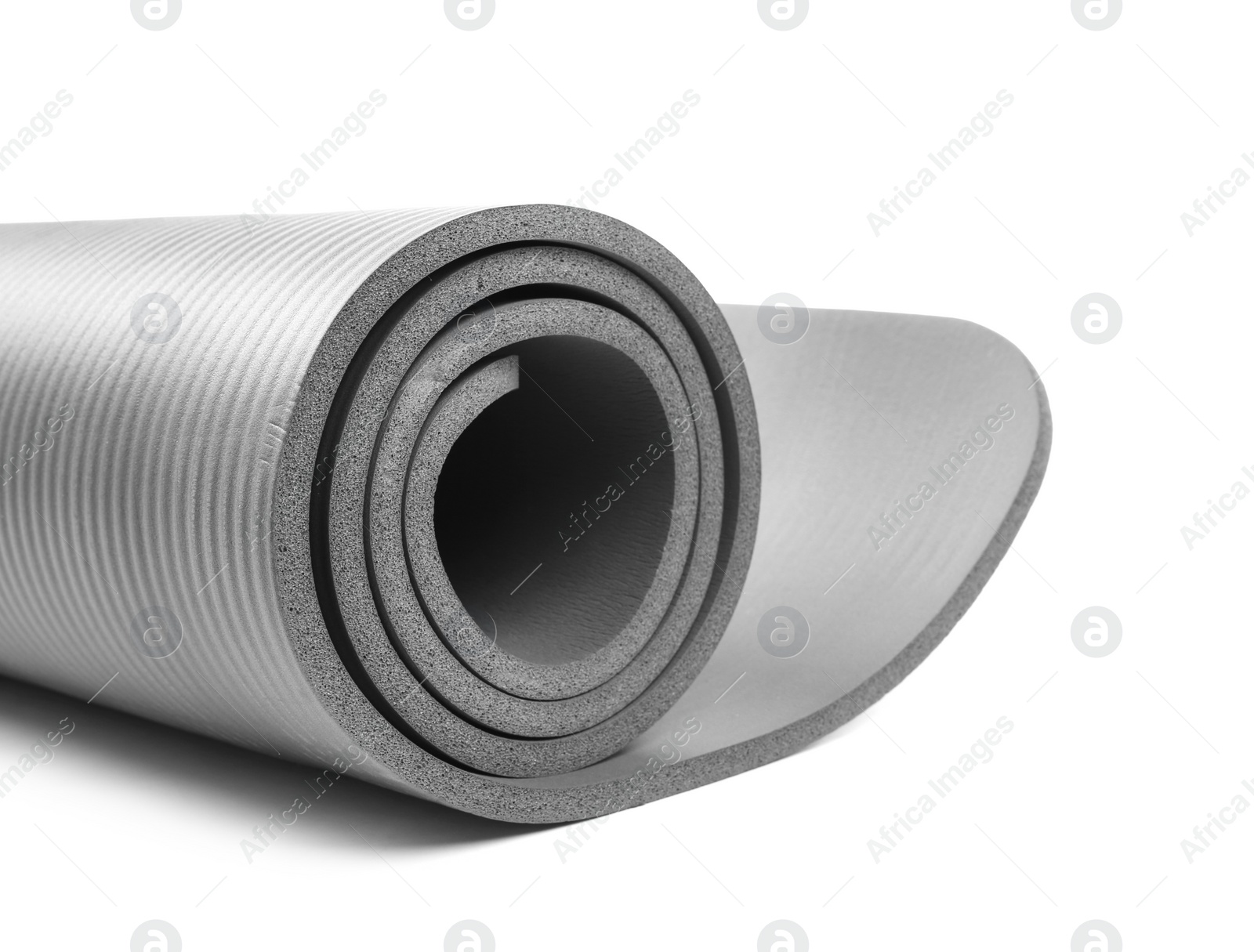 Photo of Rolled grey yoga mat on white background