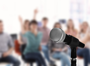 Image of Modern microphone and people at business training indoors, closeup