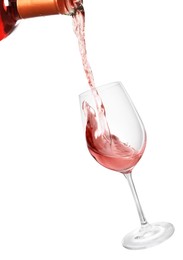 Pouring rose wine from bottle into glass on white background