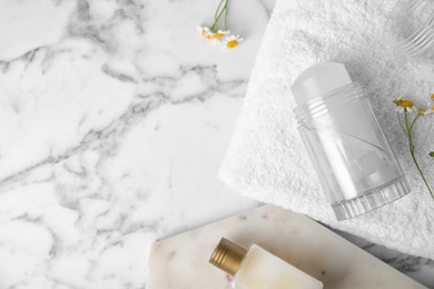 Flat lay composition with natural crystal alum deodorant and space for text on white marble table