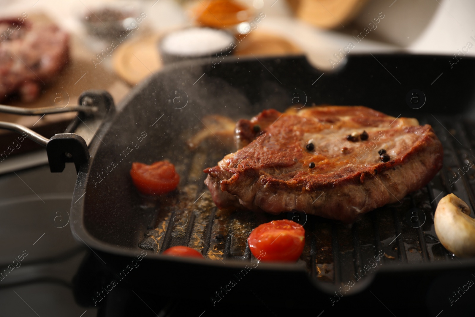 Photo of Frying pan with fresh raw meat and vegetables on stove, closeup