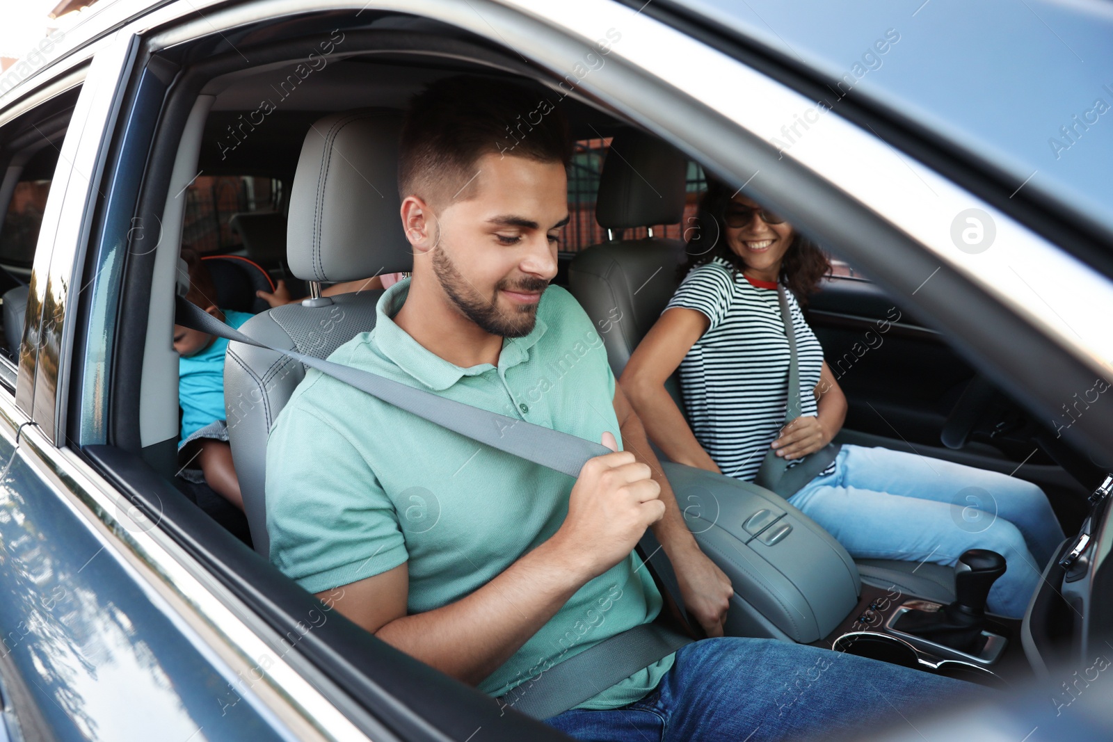 Photo of Happy family traveling by car on summer day