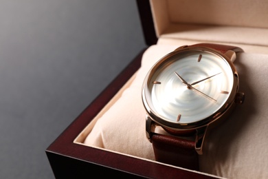 Photo of Luxury wrist watch in box on black background, closeup