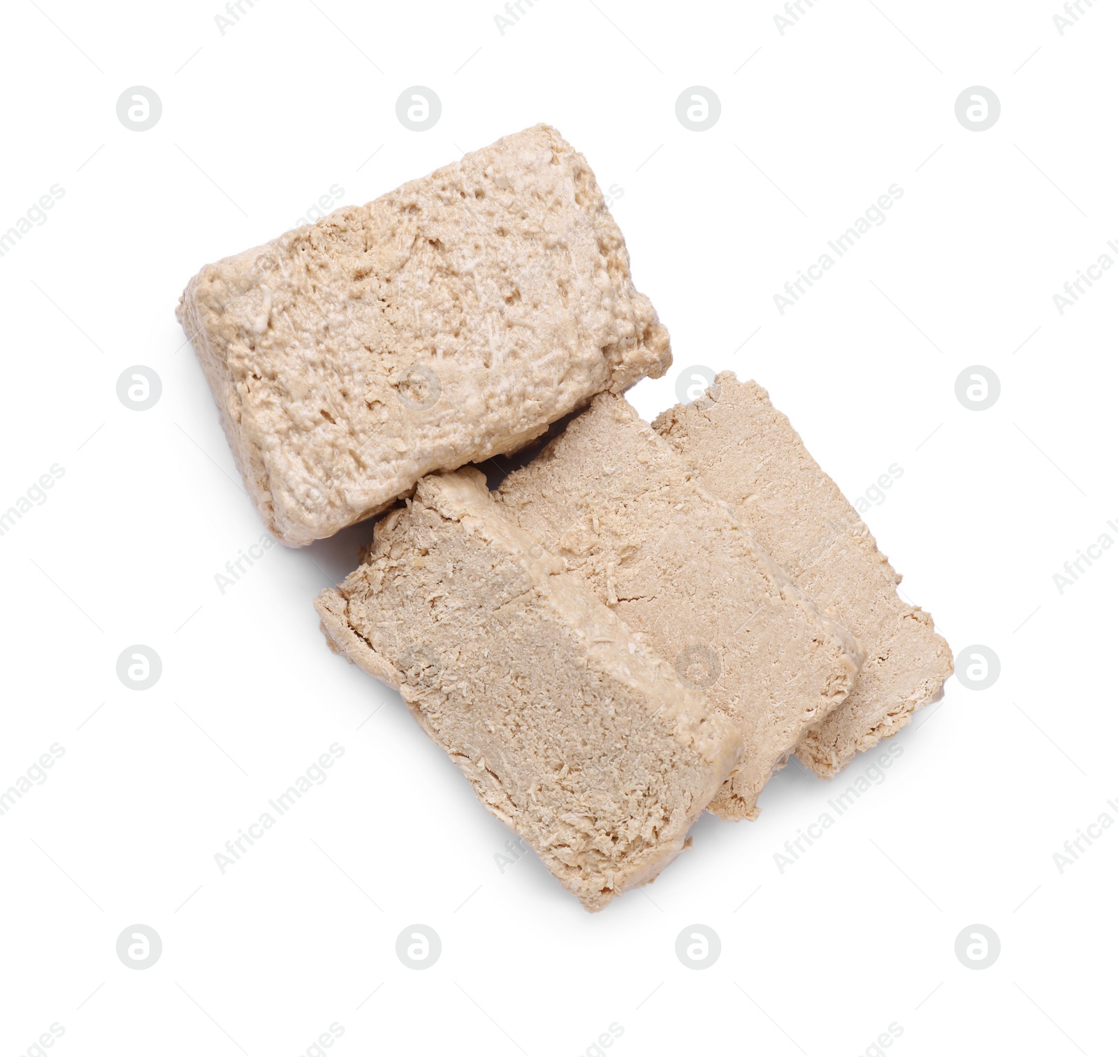 Photo of Pieces of tasty halva isolated on white, top view