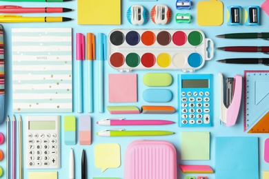 Photo of Flat lay composition with different school stationery on light blue background. Back to school