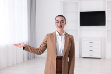 Photo of Happy real estate agent showing new apartment