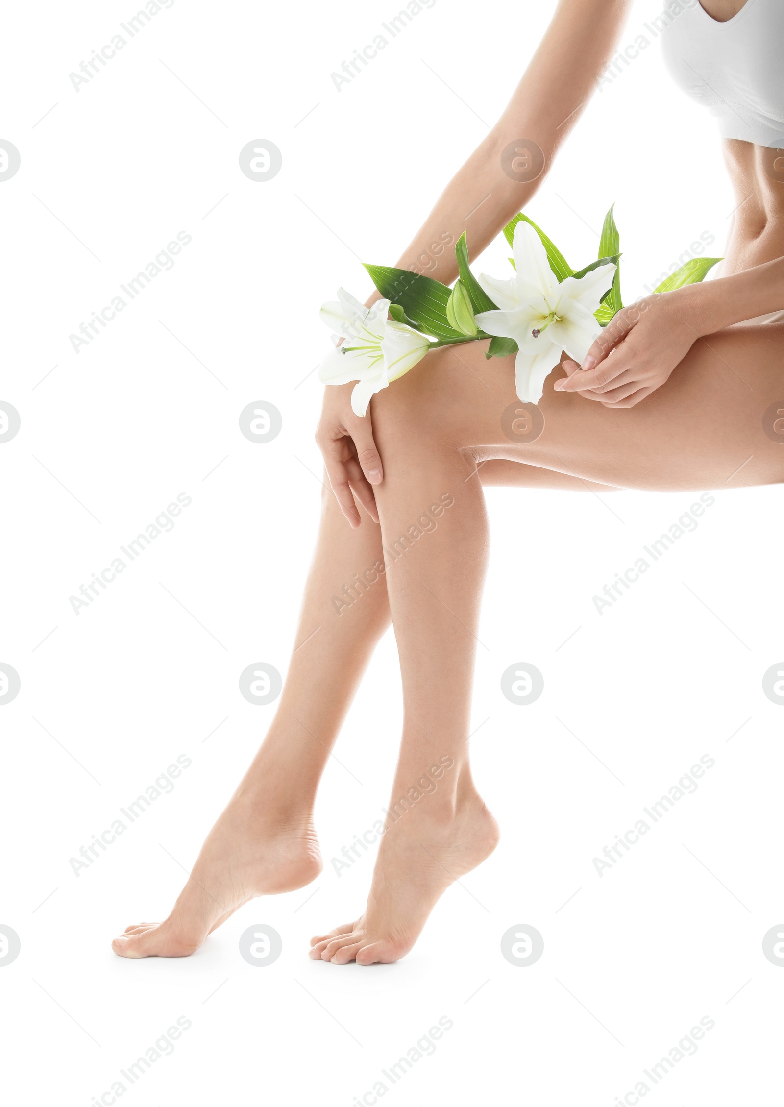 Photo of Young woman with beautiful long legs on white background, closeup