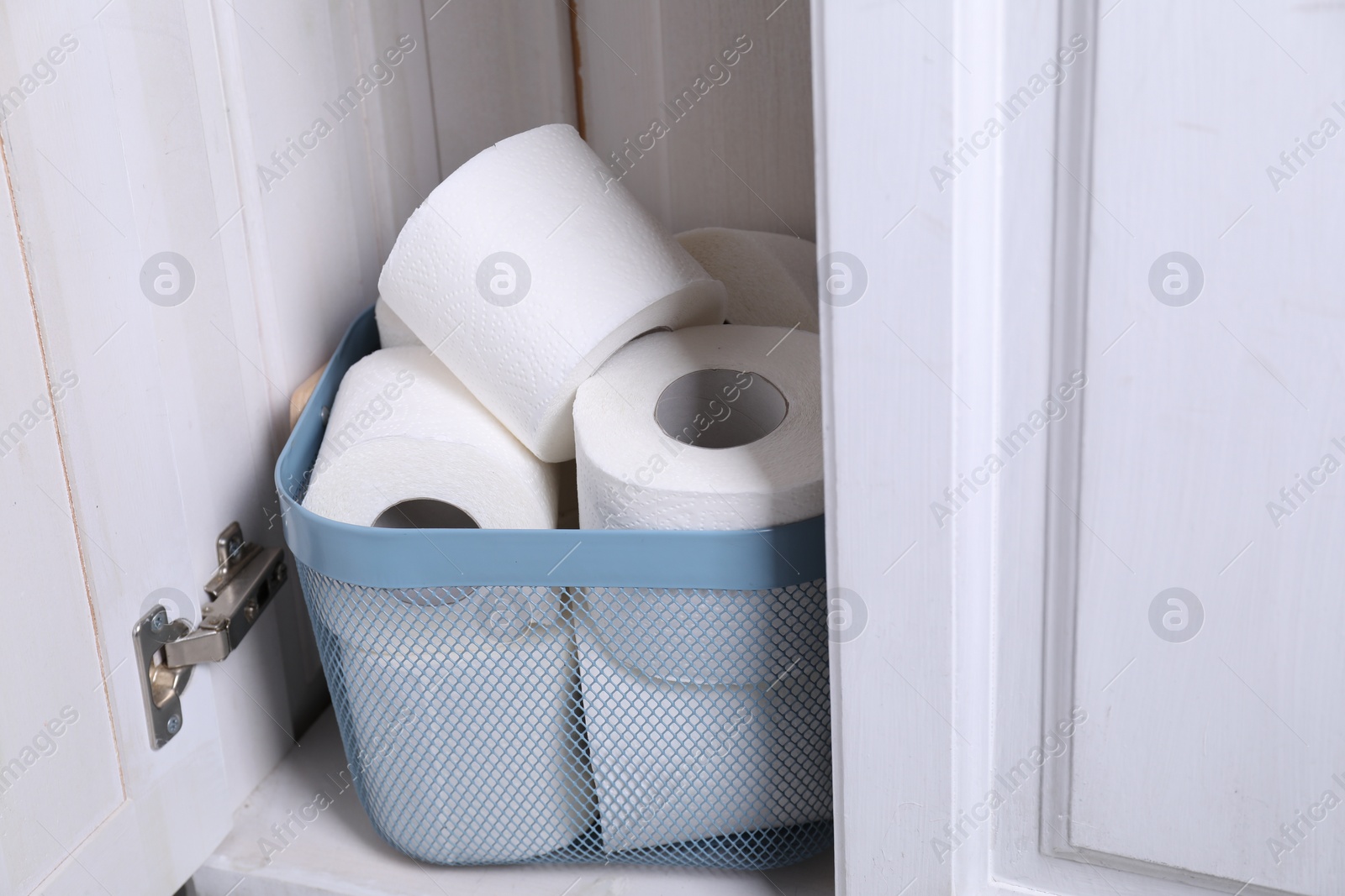 Photo of Many toilet paper rolls in cabinet indoors