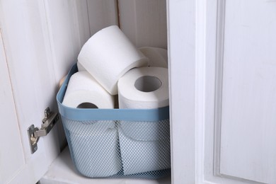 Photo of Many toilet paper rolls in cabinet indoors