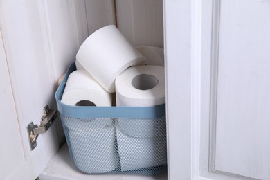 Many toilet paper rolls in cabinet indoors