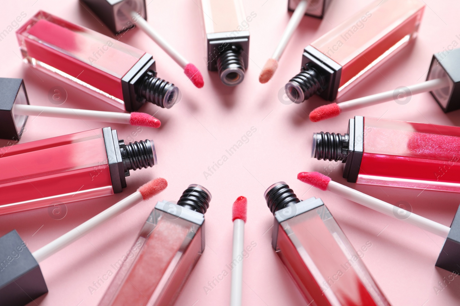 Photo of Composition of liquid lipsticks on color background