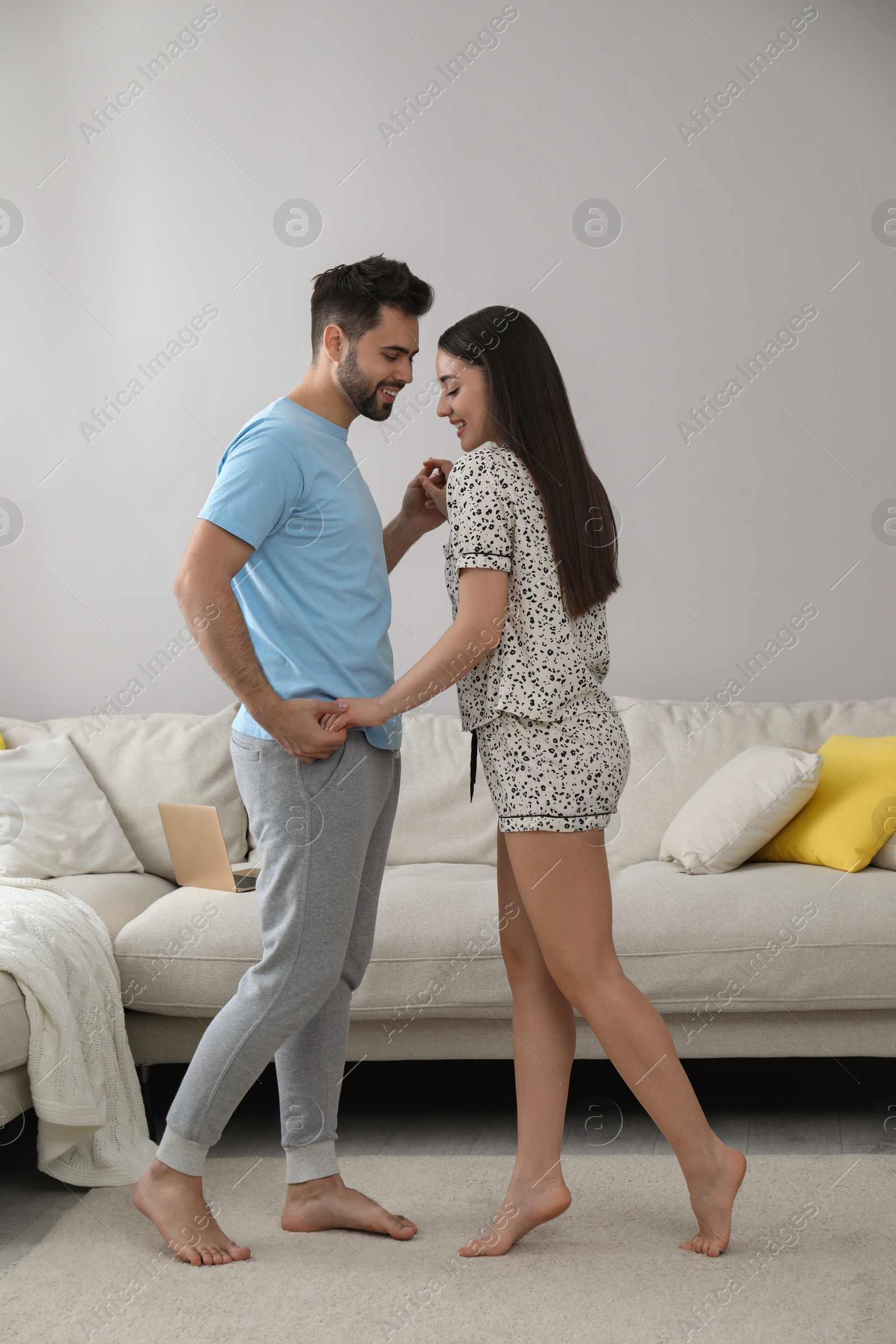 Photo of Happy couple in pajamas dancing at home