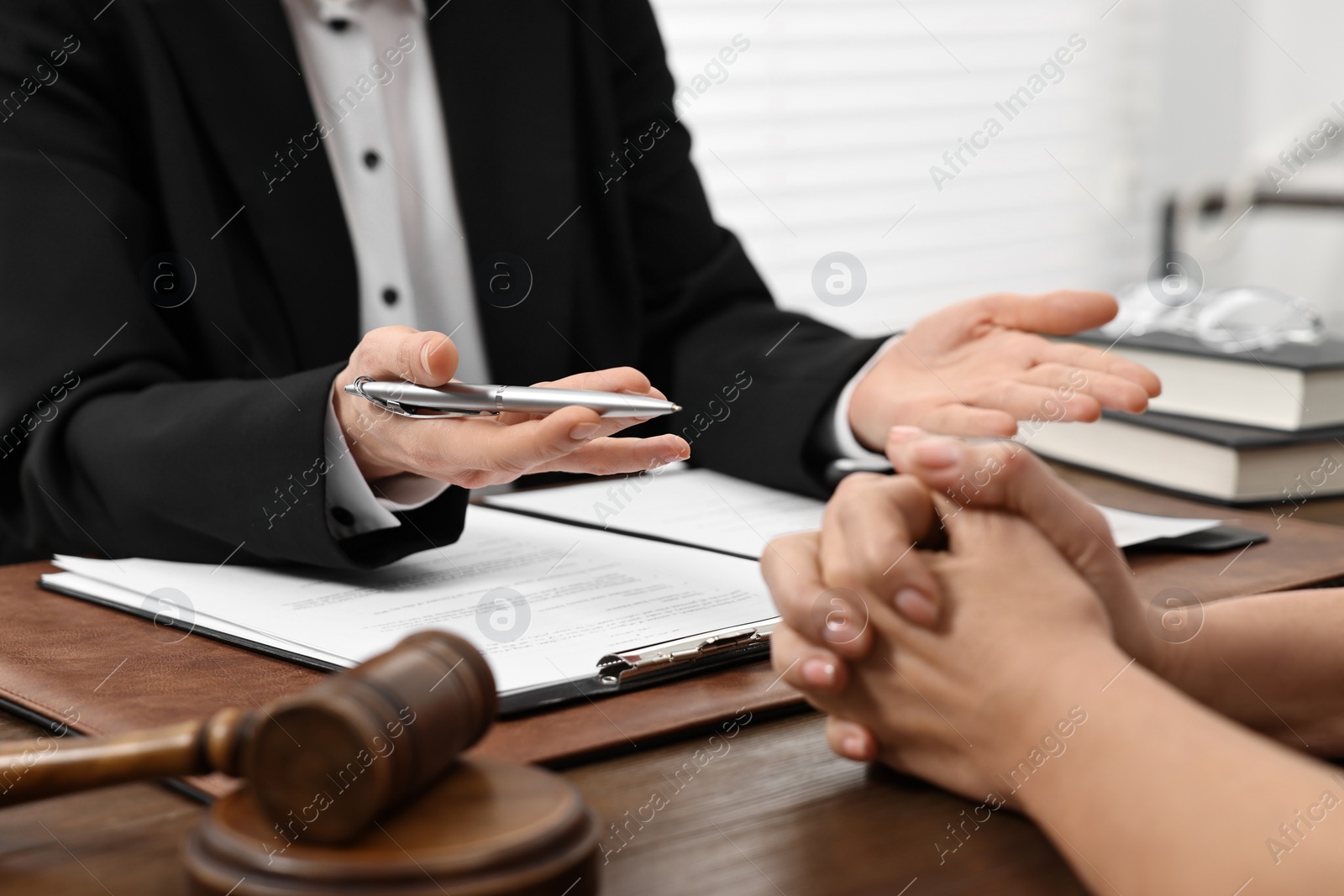 Photo of Senior woman having meeting with lawyer in office, closeup