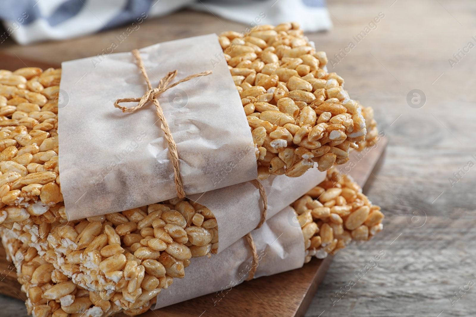 Photo of Delicious rice crispy treats on wooden table, closeup