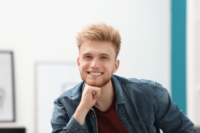 Portrait of handsome young man in room