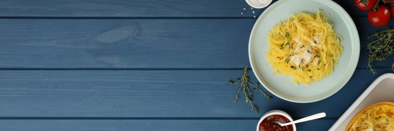 Image of Tasty spaghetti squash with cheese and thyme served on blue wooden table, flat lay. Banner design with space for text