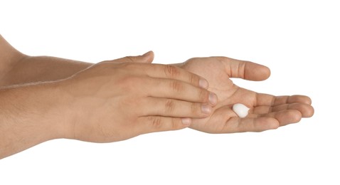 Photo of Man applying cream on hands against white background, closeup