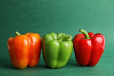 Raw ripe paprika peppers on color background