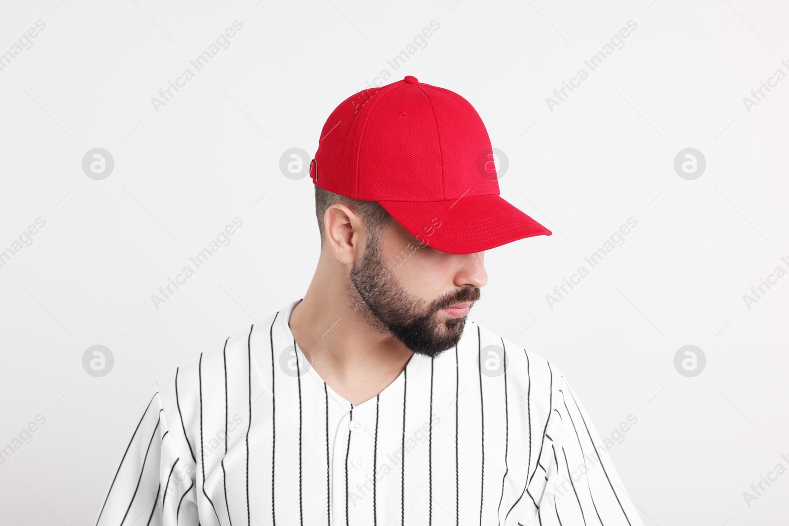 Photo of Man in stylish red baseball cap on white background