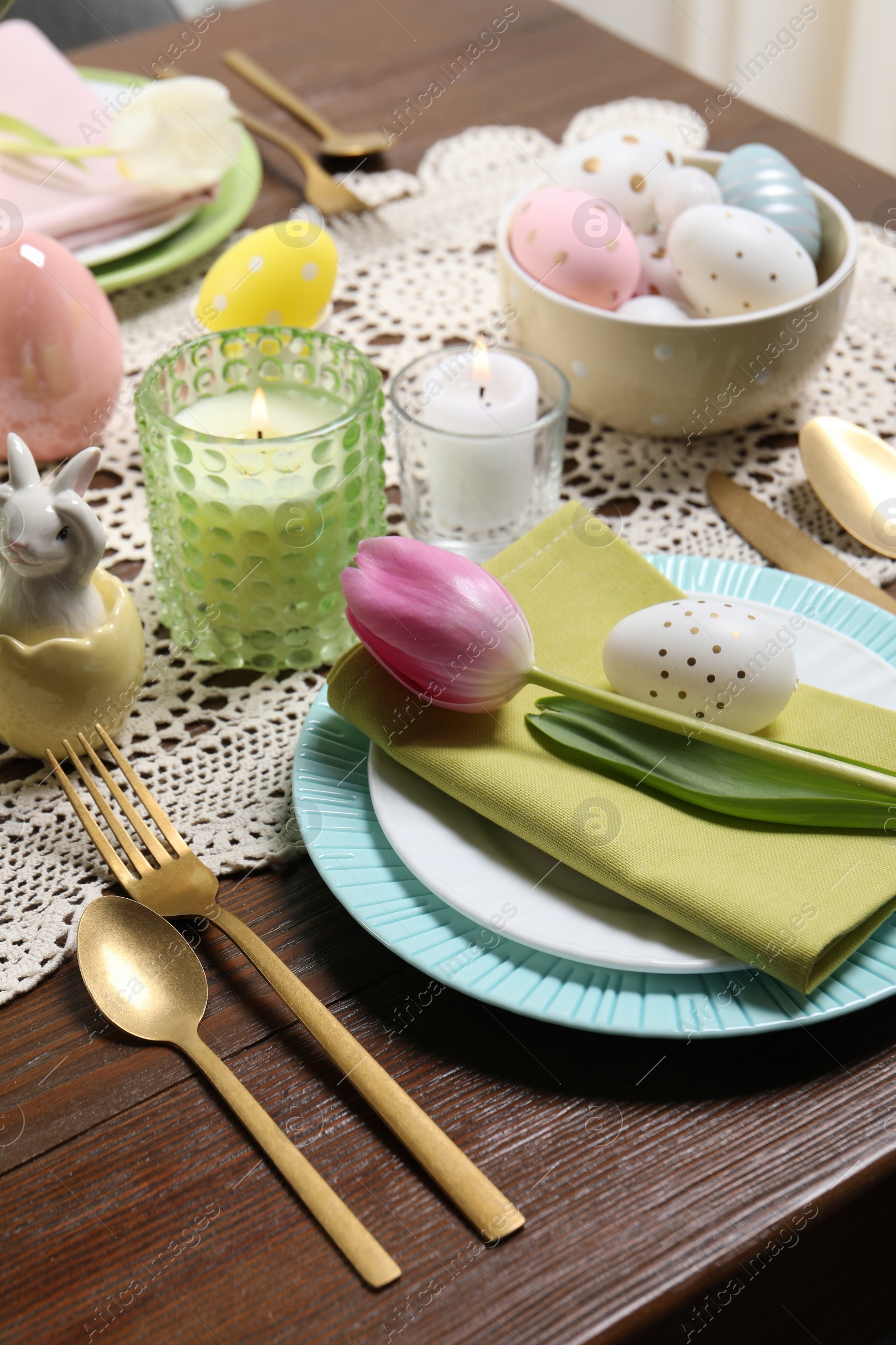 Photo of Festive table setting with painted eggs. Easter celebration