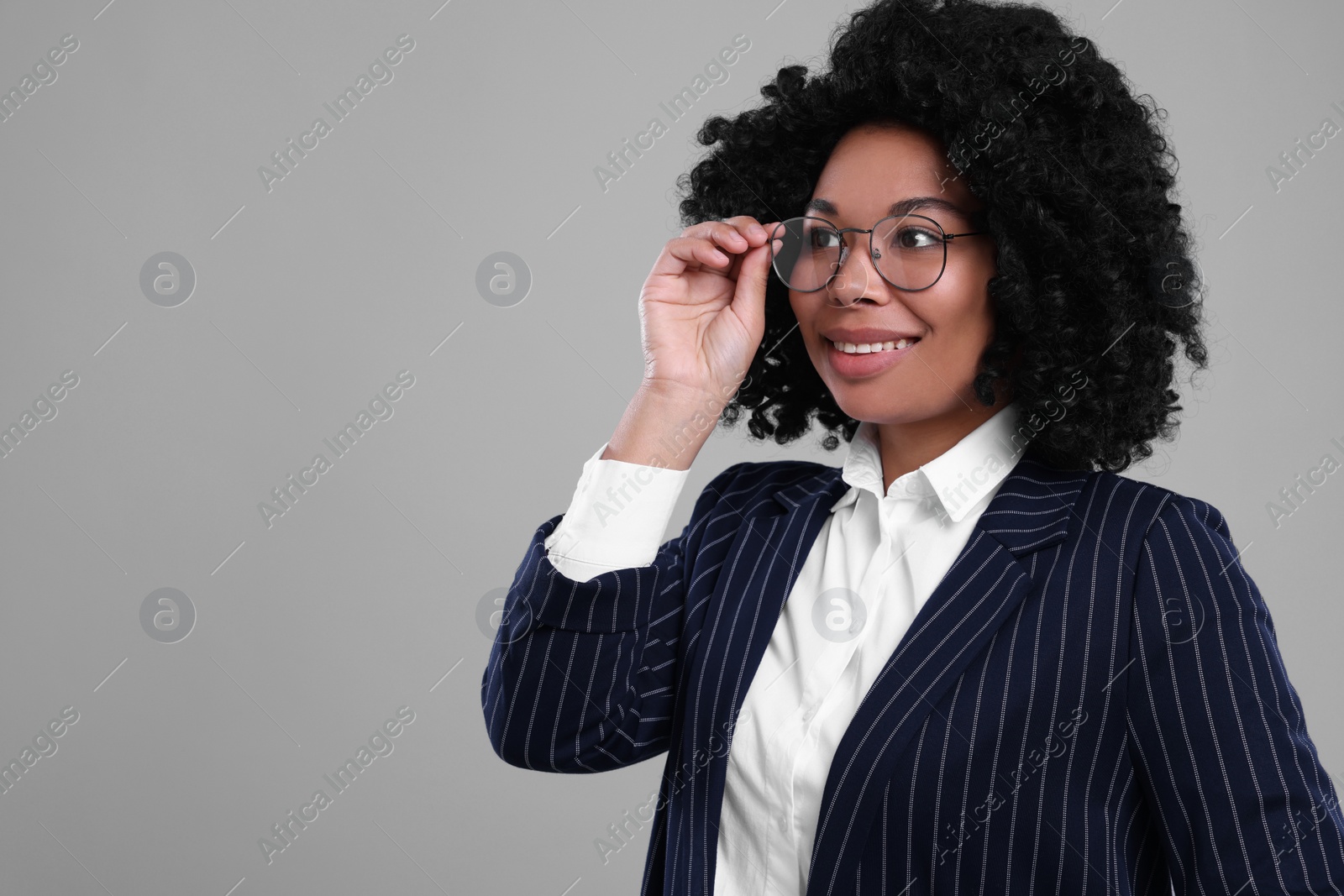 Photo of Young businesswoman in formal outfit on grey background. Space for text