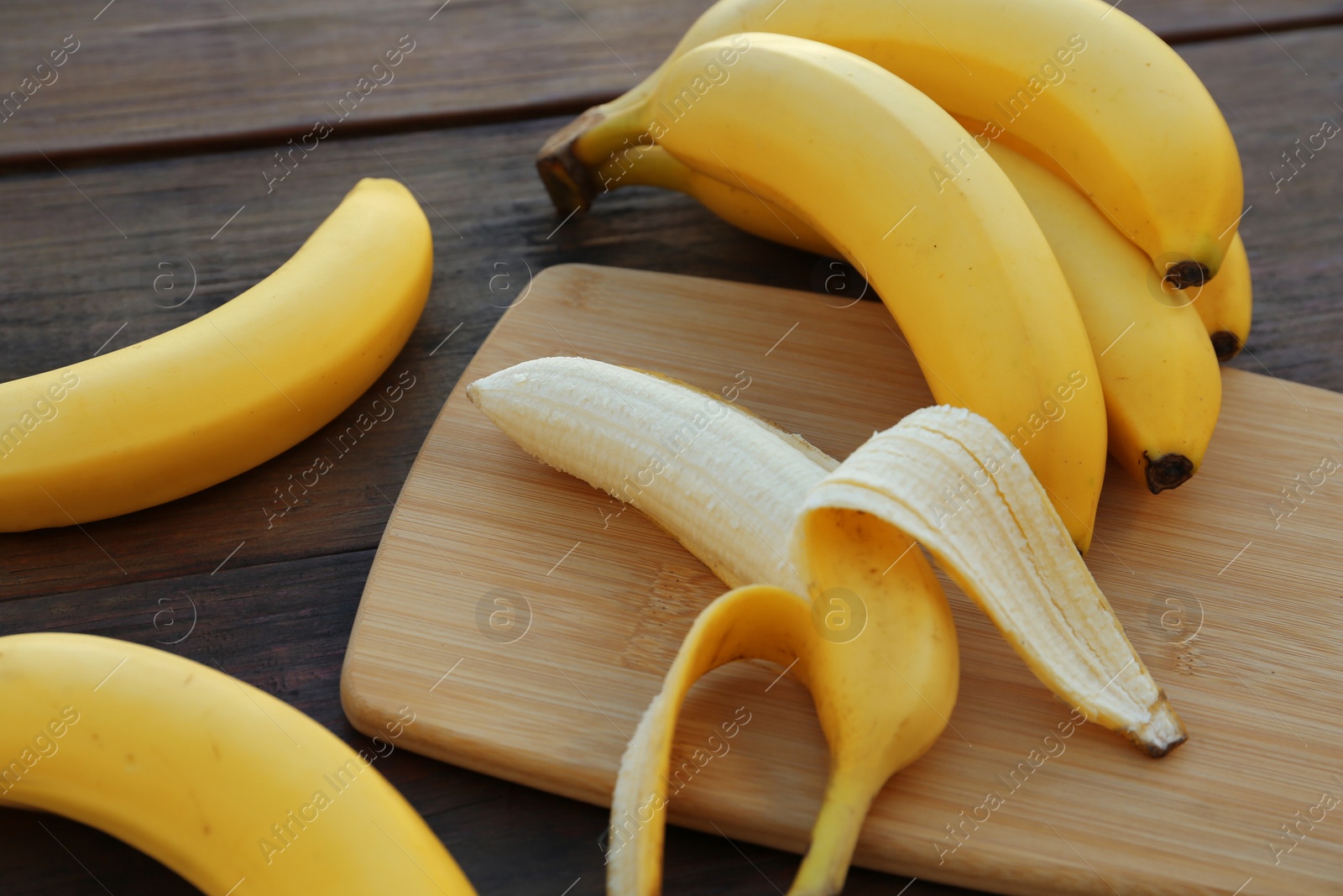 Photo of Delicious yellow bananas on wooden table, closeup