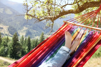 Woman resting in hammock outdoors on sunny day, closeup