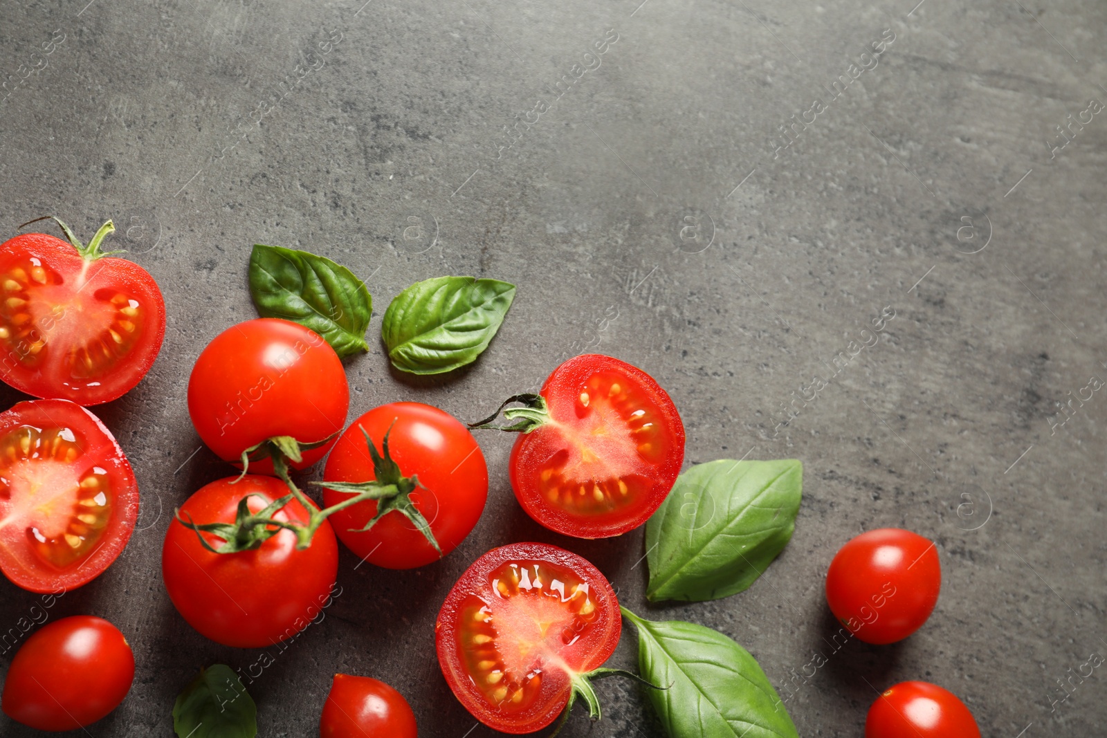 Photo of Flat lay composition with ripe cherry tomatoes and basil leaves on color background. Space for text